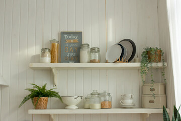 Cozy kitchen in light home interior with pastel colors, horizontal photo of country house in natural style, kitchen table and kitchenware