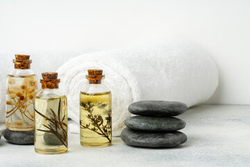Organic essential aroma oil with herbs and towels, spa concept