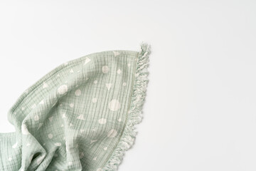 Green muslin blanket for kids on white background