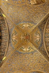 Fototapeta na wymiar Ornately decorated domed ceiling with gold-painted accents inside the Aachen Cathedral in Germany