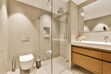 a modern bathroom with wood cabinets and white fixtures on the walls, along with a walk - in shower stall