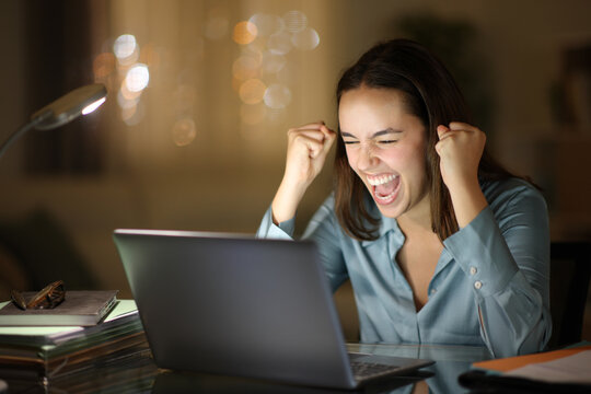Excited worker celebrating online in the night