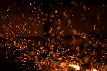 The texture of the fire. Sparks in the dark. Flames on a black background.