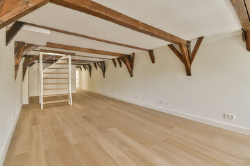 an empty room with wood flooring and exposed beams on the ceiling above it is a staircase leading...