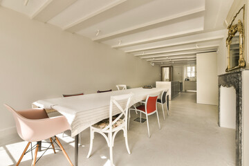 a dining room with chairs and a fire place in the middle of the room that is being used for cooking