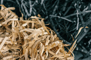 Beige and black color shredded paper . Gift box filler background