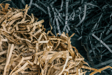 Beige and black color shredded paper . Gift box filler background