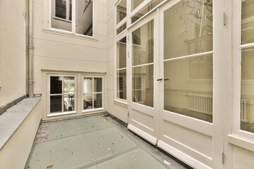 the inside of a building with broken windows and debris scattered on the ground in front of the door to the room