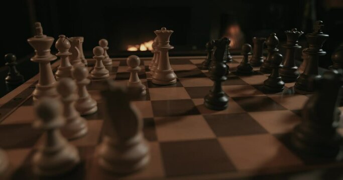 A chess game set in a fireplace atmosphere