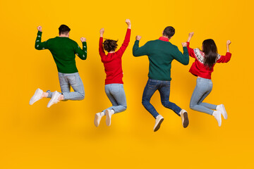 Fototapeta na wymiar Back view photo of best buddies jumping with raise fists up enjoy newyear christmas x mas discounts isolated bright color background