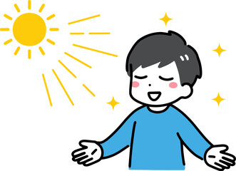 両手を広げて日光を浴びる私服の若い男性