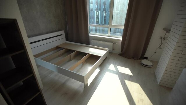 The furniture assembler assembles the bed frame, do it yourself and assemble new furniture