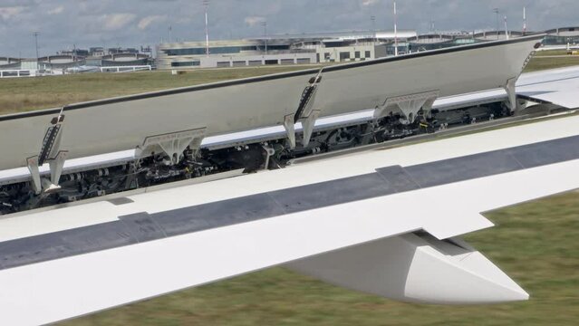 The wing with flaps of the aircraft working during the landing