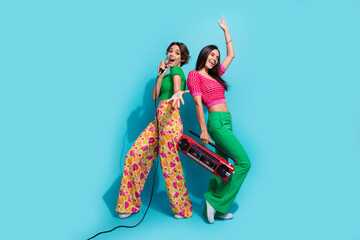 Full body photo of two pretty girls concert beautiful famous celebrity singing microphone sound boombox isolated on blue color background