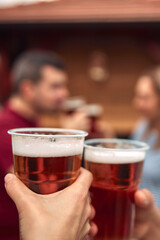 Group of friends enjoying cold beer at a backyard party.