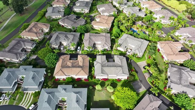 Aerial Princeville luxury homes condo golf course Kauai Hawaii. Expensive luxury homes, resort, condominium golf club near coast. Green landscape. Hawaiian Island. Garden Isle. Economy tourism based.