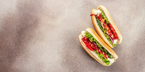 Hot dog with sausage in a bun with sauces on a light background, Fast food menu for kids, Long banner format. top view