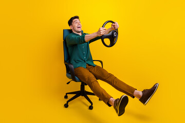 Photo of cheerful funky man dressed stylish clothes looking empty space fast speed test drive...