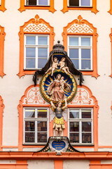 Elements of facade of house with bas-reliefs and old frescoes in Landshut, Bavaria, Germany. 