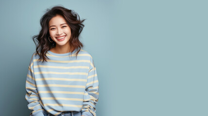 Obraz premium An Asian woman wearing striped sweatshirt isolated on pastel background