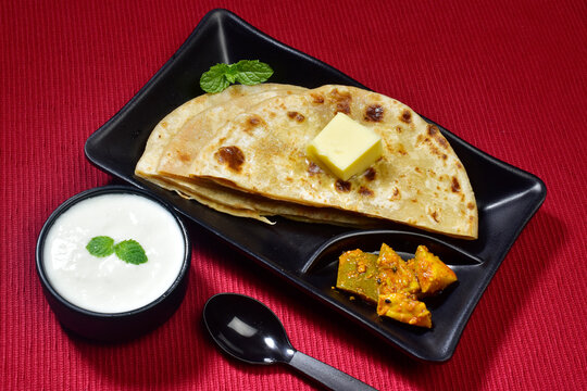 Stuffed paratha with dahi and achar, healthy indian breakfast with full of calories
