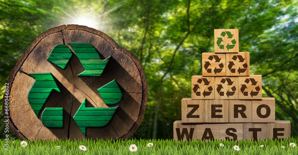 Poster stack of wooden blocks with text zero waste and recycling symbols, on a green meadow with a cross se