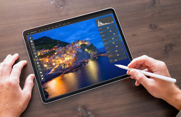 Person using photo editor on digital tablet