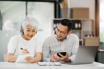 Business team take notes and use the calculator with calculations about the expenses at the office.