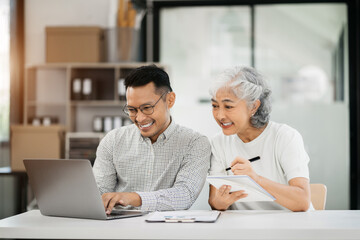 Fototapeta premium Office worker lifestyle people. Business people writing notes on book and using laptop. home office workplace lifestyle people.