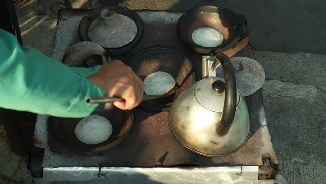 Lift the cooked serabi from the clay pot, Serabi is a typical Sundanese food like pancakes but has a savory taste.
