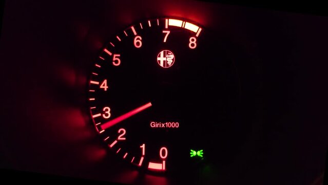 Modern car tachometer gauge showing engine being revved up. Close up shot, real time, no people