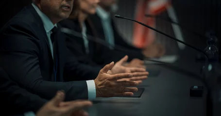 Foto op Canvas Close Up On Hands of Caucasian Male Organization Representative Speaking at Economic Conference. Head Of USA Delegation Delivering Speech at International Political Summit. Diverse Delegates Listening © Gorodenkoff