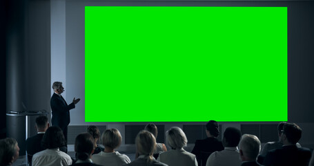 Corporate Event: Caucasian Male Tech CEO Giving Presentation On Green Screen Chromakey Projector Display To Colleagues In Conference Room Of Startup Office. Man Talking About Business Objectives. - obrazy, fototapety, plakaty