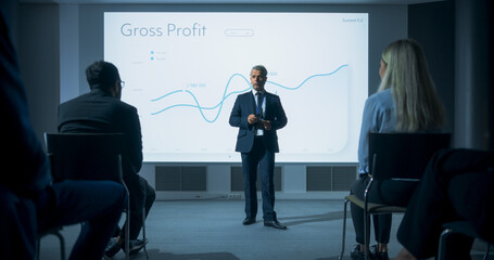 Corporate Event: Caucasian Male Tech CEO Giving Presentation To Colleagues or Investors In Conference Room Of Innovative Startup Office. Man Talking About Business Objectives and Profit Margins. - obrazy, fototapety, plakaty