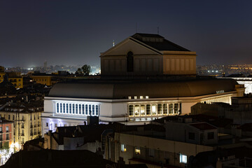 Aerial view of the Teatro Real (Royal Theatre) in Madrid at night, surrounded by illuminated buildings