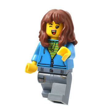 Lego minifigure happy pretty girl or woman influencer isolated on white. Editorial illustrative image of popular children plastic toy.