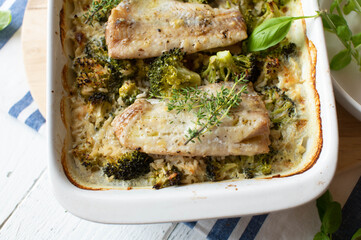 Fish bake with rice and broccoli in a casserole dish