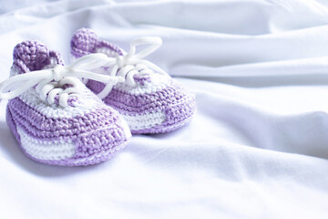 Fototapeta na wymiar Knitted booties socks on a white background for newborns