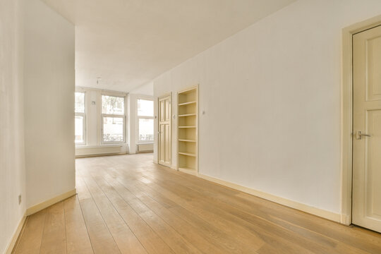 an empty room with wood flooring and white paint on the walls, there is no one person in it