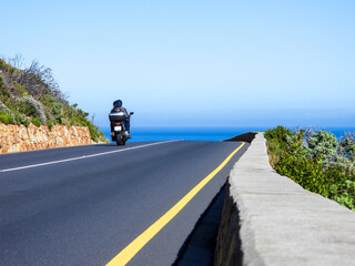 2 people on a motorcycle travelling along the beautiful Clarence Drive, False Bay, Western Cape