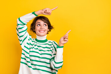 Photo of funny cute lady indicating fingers empty copy space promotion placard wear pullover isolated yellow color background - obrazy, fototapety, plakaty