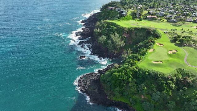 Aerial Princeville luxury golf course Queens Bath Kauai Hawaii 1. Expensive luxury homes, resort, condominium, golf club coast. Green landscape. Hawaiian Island. Garden Isle. Economy tourism based.