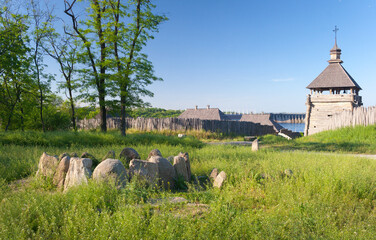 Ancient stone cromlech on sanctuary near the Zaporozhian Sich cossacks fortress with Dneproges dam on the background, Khortytsia island, Zaporizhzhia, Ukraine
