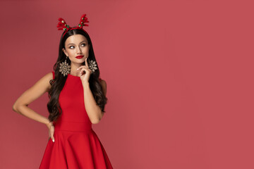 A beautiful girl in a New Year's outfit, on a pink background.