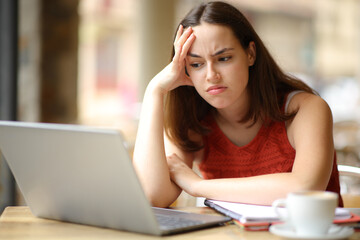 Frustrated student checking content on laptop