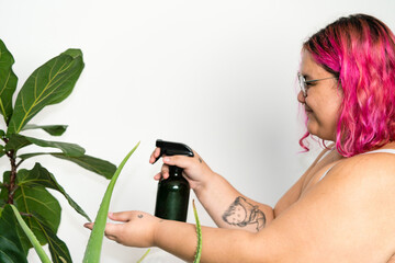 Woman spraying their house plants