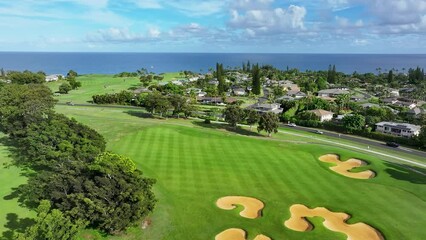 Aerial Princeville residential and resort golf course Kauai Hawaii. Expensive luxury homes, resort, condominium, golf club coast. Green landscape. Hawaiian Island. Garden Isle. Economy tourism based.