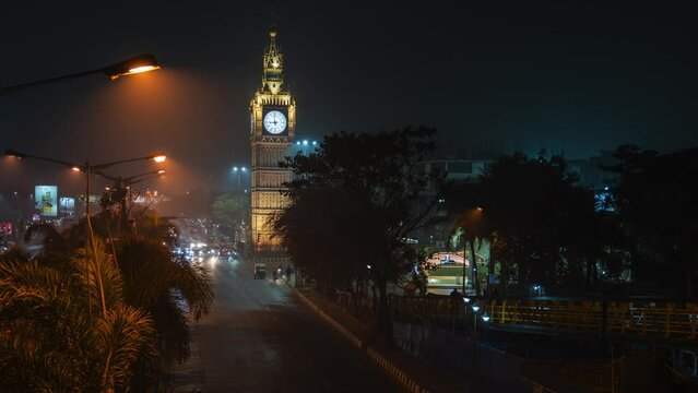 Timelapse view of traffic in front of architectural landmark Lake Town Clock Tower at night in Kolkata, West Bengal, India.