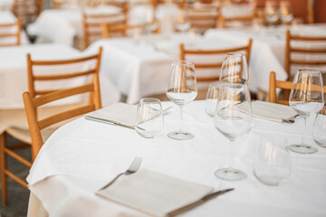 Tables with clean dishes in the restaurant are set for receiving guests - siesta and the restaurant...