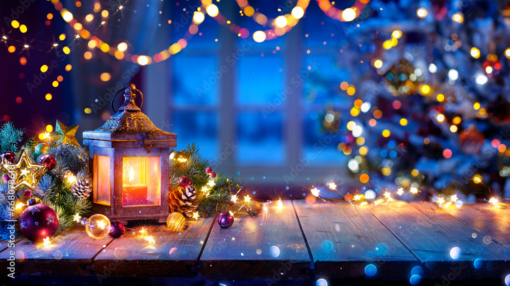 Wall mural lantern and christmas tree glowing on table with decoration and string lights - bokeh and glittering